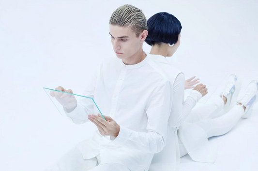 A person interacting with a holographic representation of a loved one, symbolizing the merging of technology and memory in the grief-tech industry.